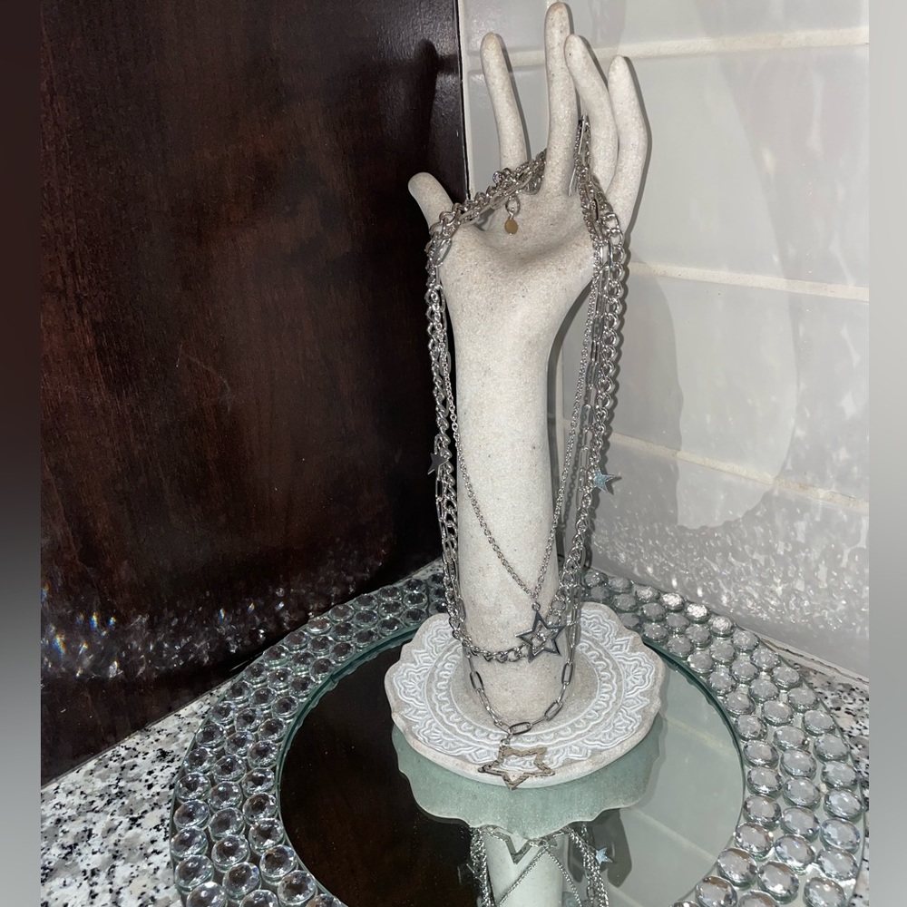 Triple layered silver star necklace.